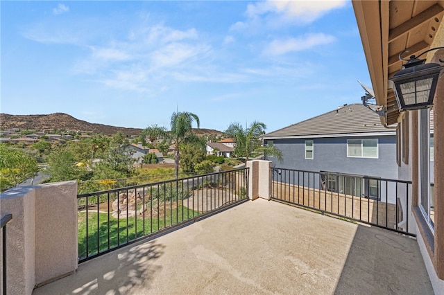 view of patio / terrace featuring a mountain view and a balcony