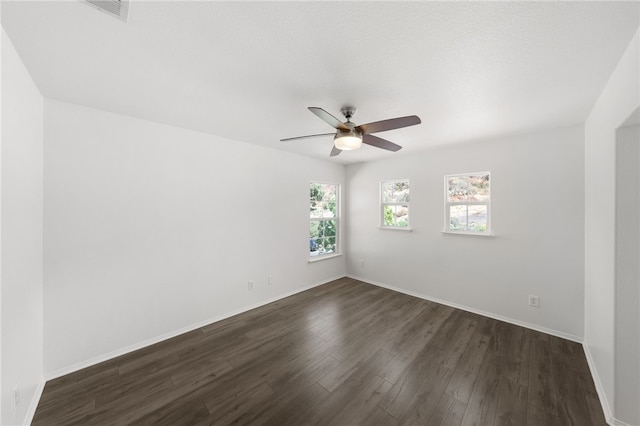 spare room with dark hardwood / wood-style floors and ceiling fan