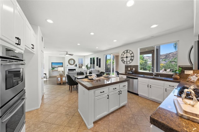 kitchen featuring white cabinets, a wealth of natural light, sink, and appliances with stainless steel finishes