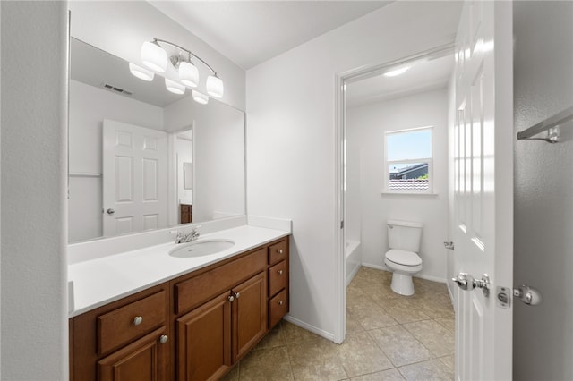 bathroom featuring tile patterned flooring, vanity, and toilet