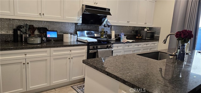 kitchen with backsplash, stainless steel appliances, white cabinets, and sink