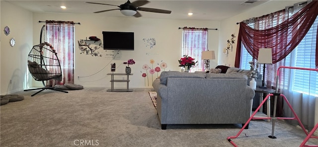 carpeted living room featuring ceiling fan