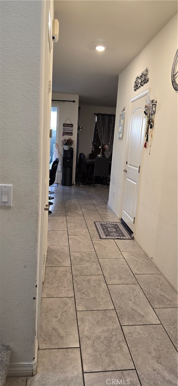 hallway with light tile patterned flooring