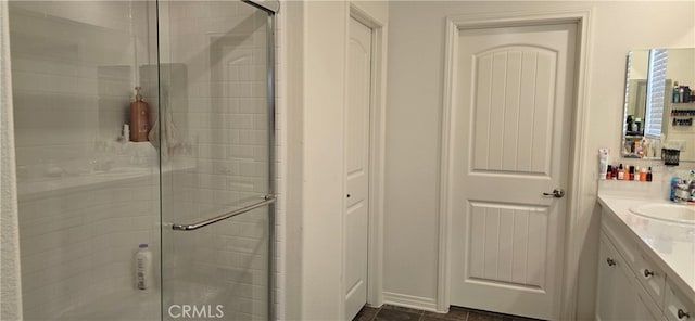 bathroom featuring vanity and a shower with door