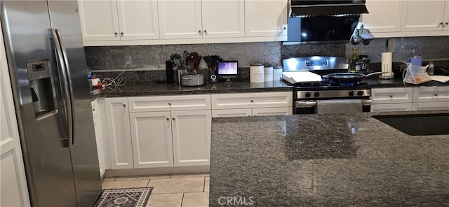 kitchen featuring white cabinets, dark stone countertops, and appliances with stainless steel finishes