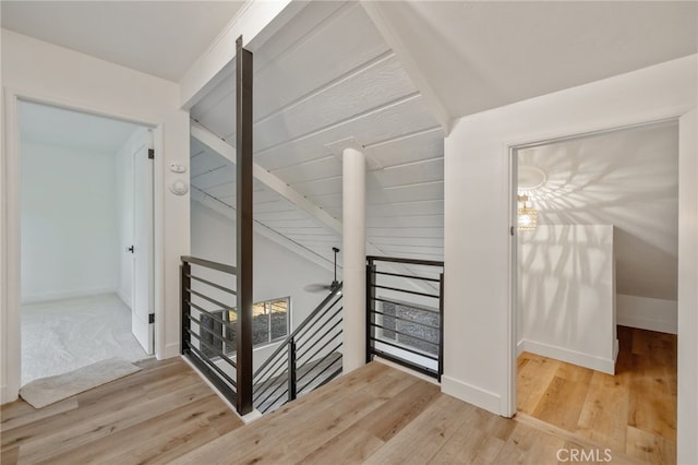 stairs featuring hardwood / wood-style floors