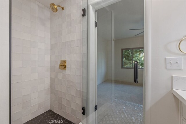 bathroom featuring ceiling fan and walk in shower