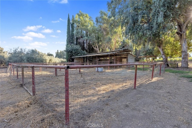 view of yard with an outbuilding and a rural view