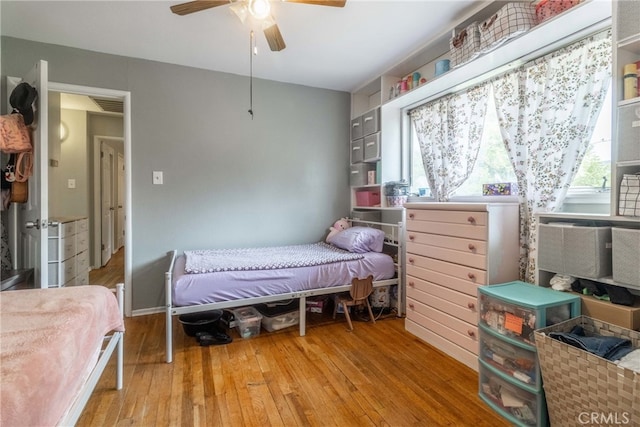 bedroom with ceiling fan and light wood-type flooring