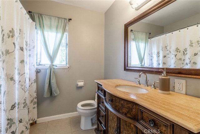 bathroom with vanity, tile patterned flooring, and toilet