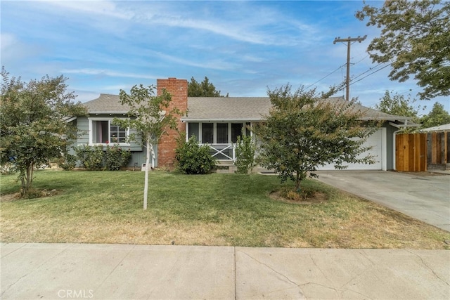 view of front of home featuring a garage and a front lawn