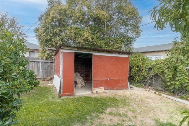 view of outbuilding with a yard