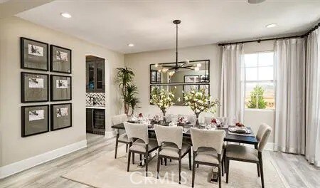 dining space featuring light hardwood / wood-style floors and a premium fireplace