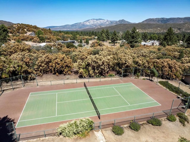 view of tennis court featuring a mountain view