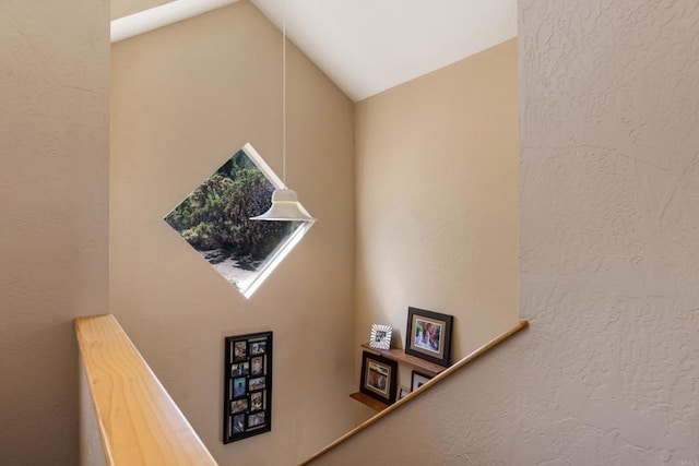 stairs featuring vaulted ceiling