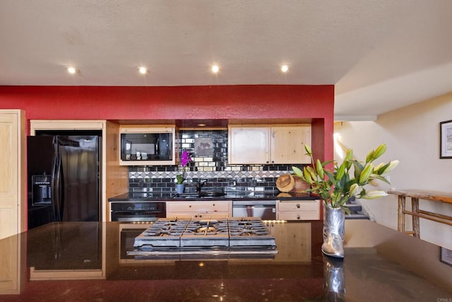 kitchen with black appliances, tasteful backsplash, and sink