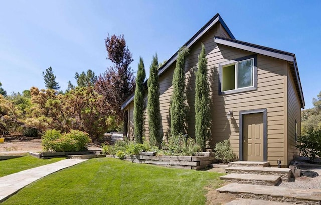 rear view of property with a yard