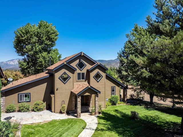 view of front facade with a mountain view and a front lawn