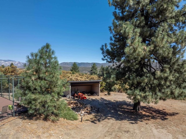 view of yard with a carport and a mountain view