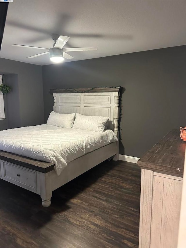 bedroom with ceiling fan and dark hardwood / wood-style flooring