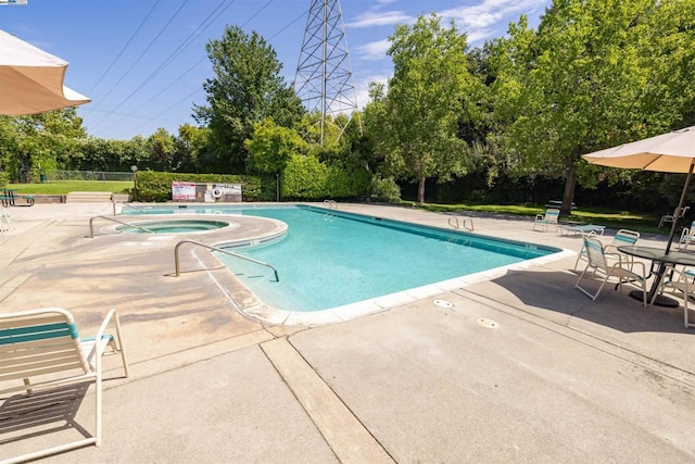 view of pool featuring a community hot tub and a patio area