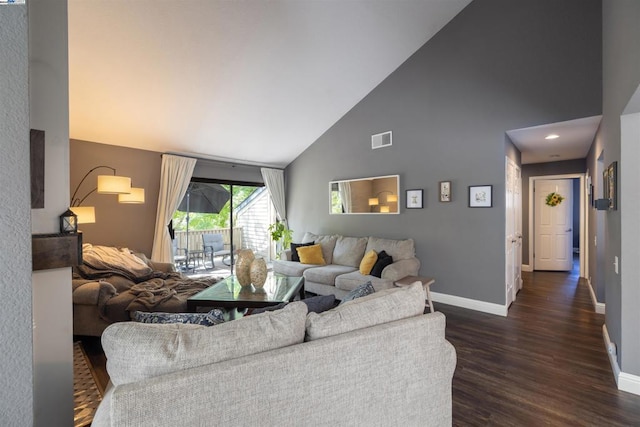 living room featuring dark wood-type flooring and high vaulted ceiling