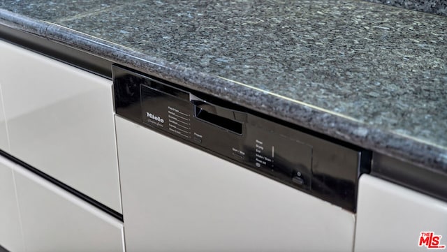 details featuring white dishwasher and white cabinets