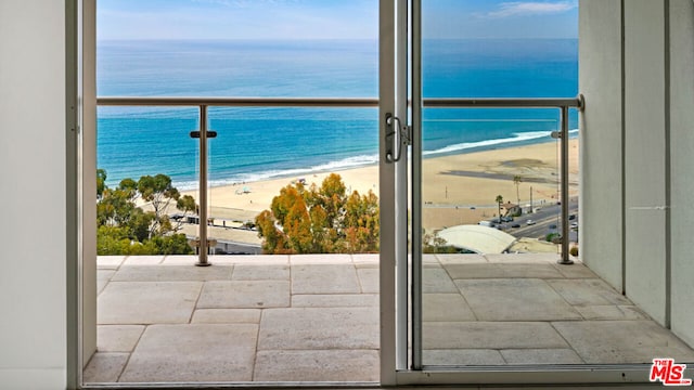 balcony with a water view and a beach view