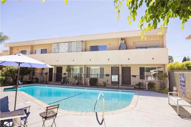 pool featuring fence and a patio