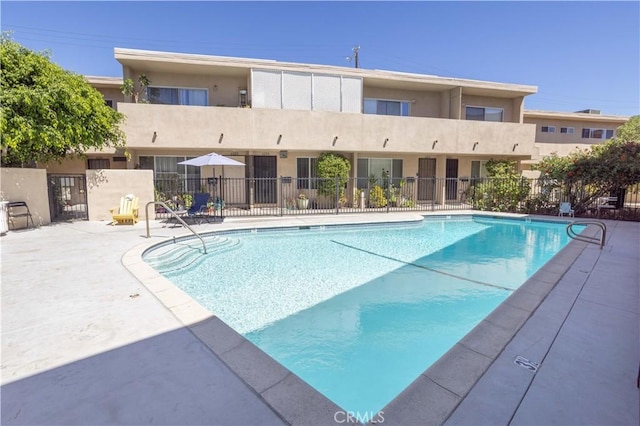 view of pool featuring fence