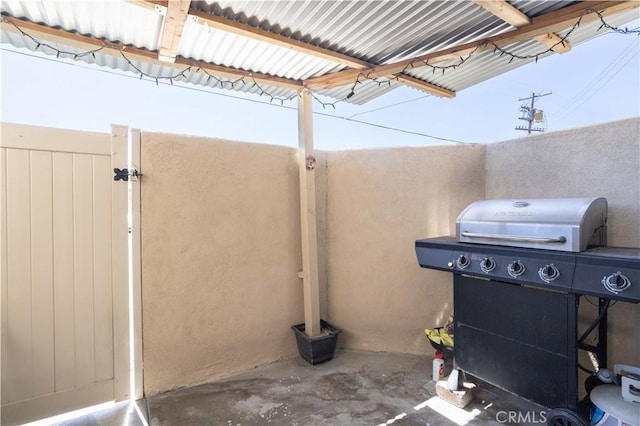 view of patio with grilling area and a gate