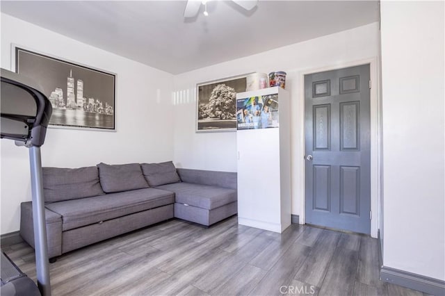 unfurnished living room featuring a ceiling fan and wood finished floors