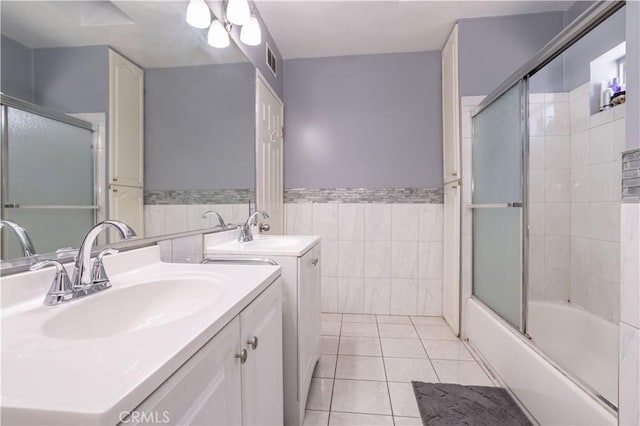 full bath featuring tile walls, a wainscoted wall, visible vents, tile patterned floors, and vanity