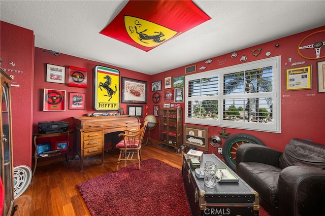 office area with wood-type flooring and a textured ceiling