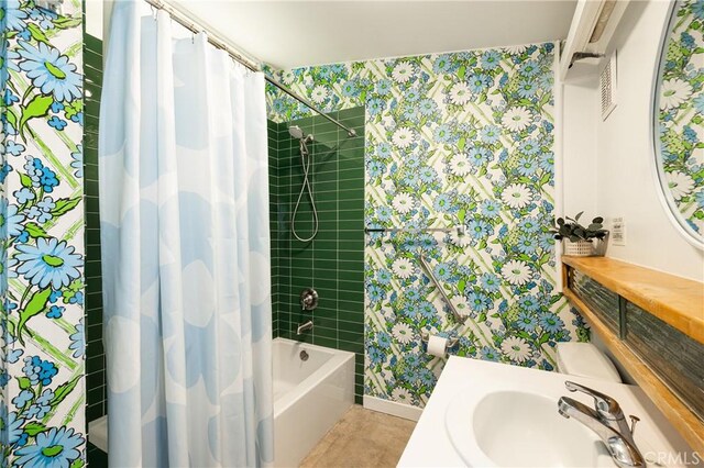 bathroom with shower / tub combo with curtain and sink