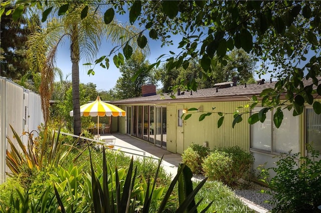 back of property with a patio