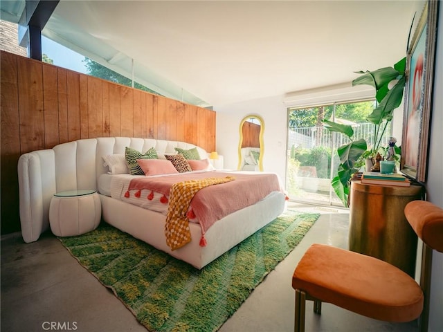 bedroom featuring vaulted ceiling and access to outside