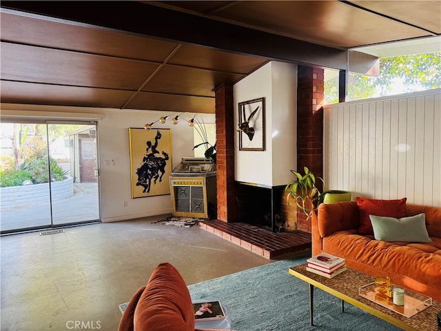 living room with a fireplace and a wealth of natural light