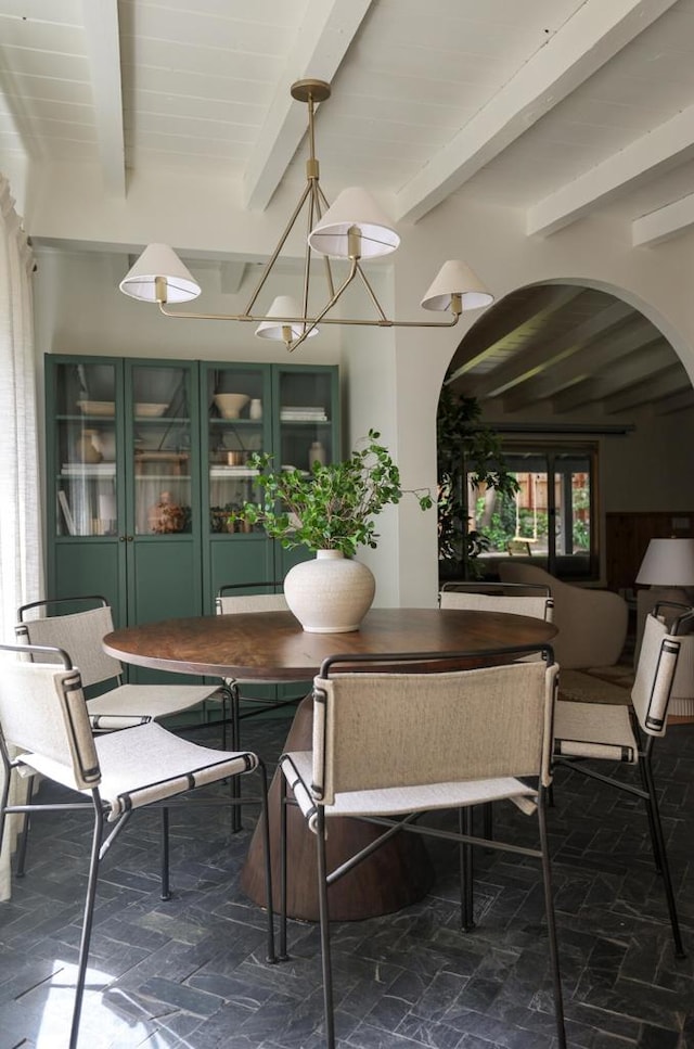 dining room featuring beamed ceiling