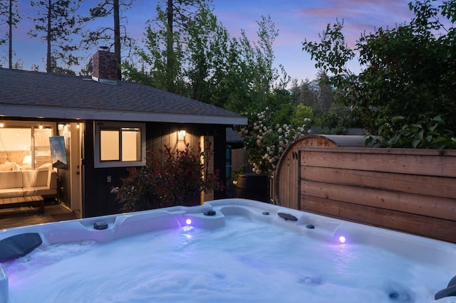 exterior space with a hot tub