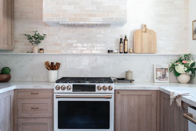 kitchen with decorative backsplash and high end range