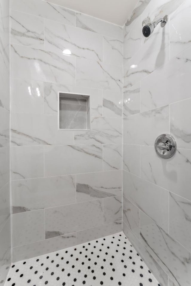 bathroom with a tile shower