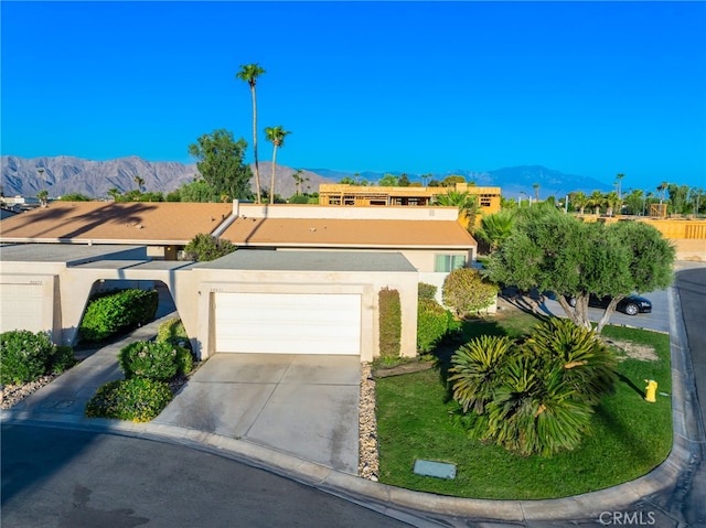 view of front facade featuring a garage and a mountain view