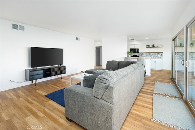 living room with light hardwood / wood-style flooring