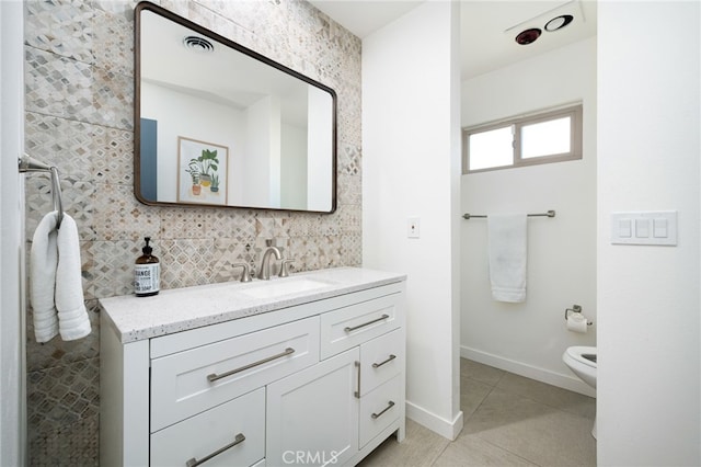 bathroom with vanity, tile patterned flooring, and toilet