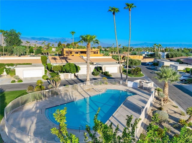 view of swimming pool with a mountain view