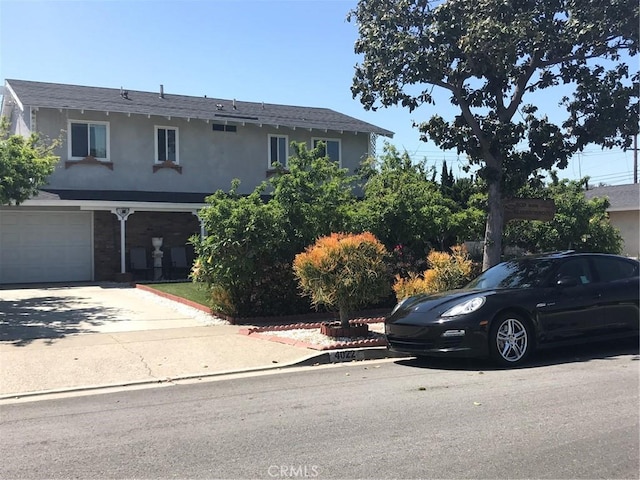 view of front of home featuring concrete driveway and stucco siding