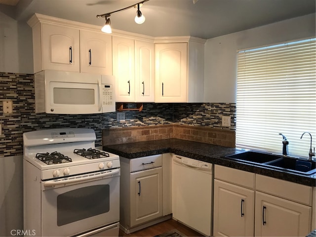 kitchen featuring white cabinets, white appliances, and a sink