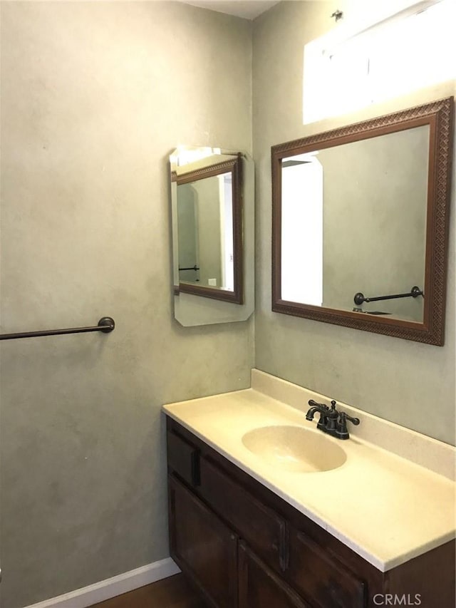 bathroom with vanity and baseboards