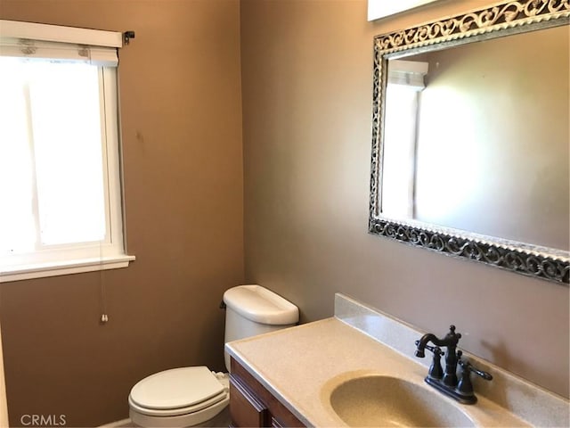 bathroom with toilet and vanity